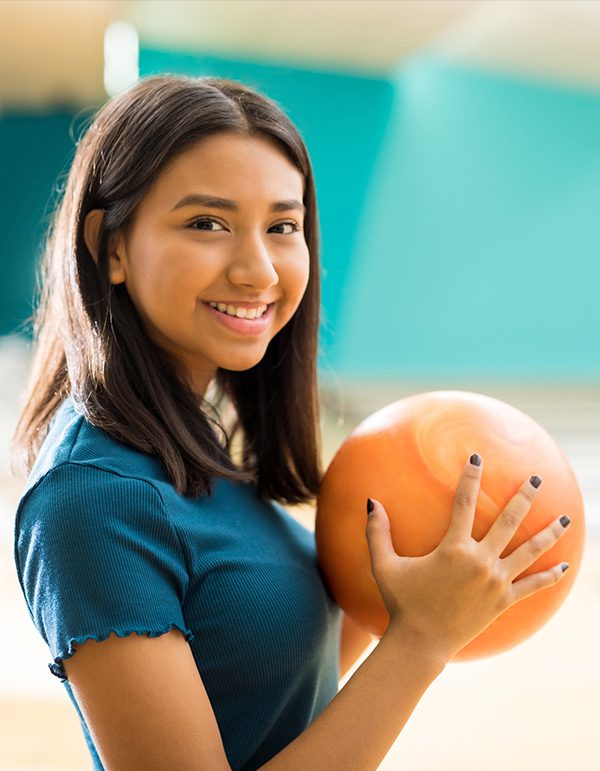 Girl-With-Ball-Having-Fun-At-Bowling-Alley-In-Clubs